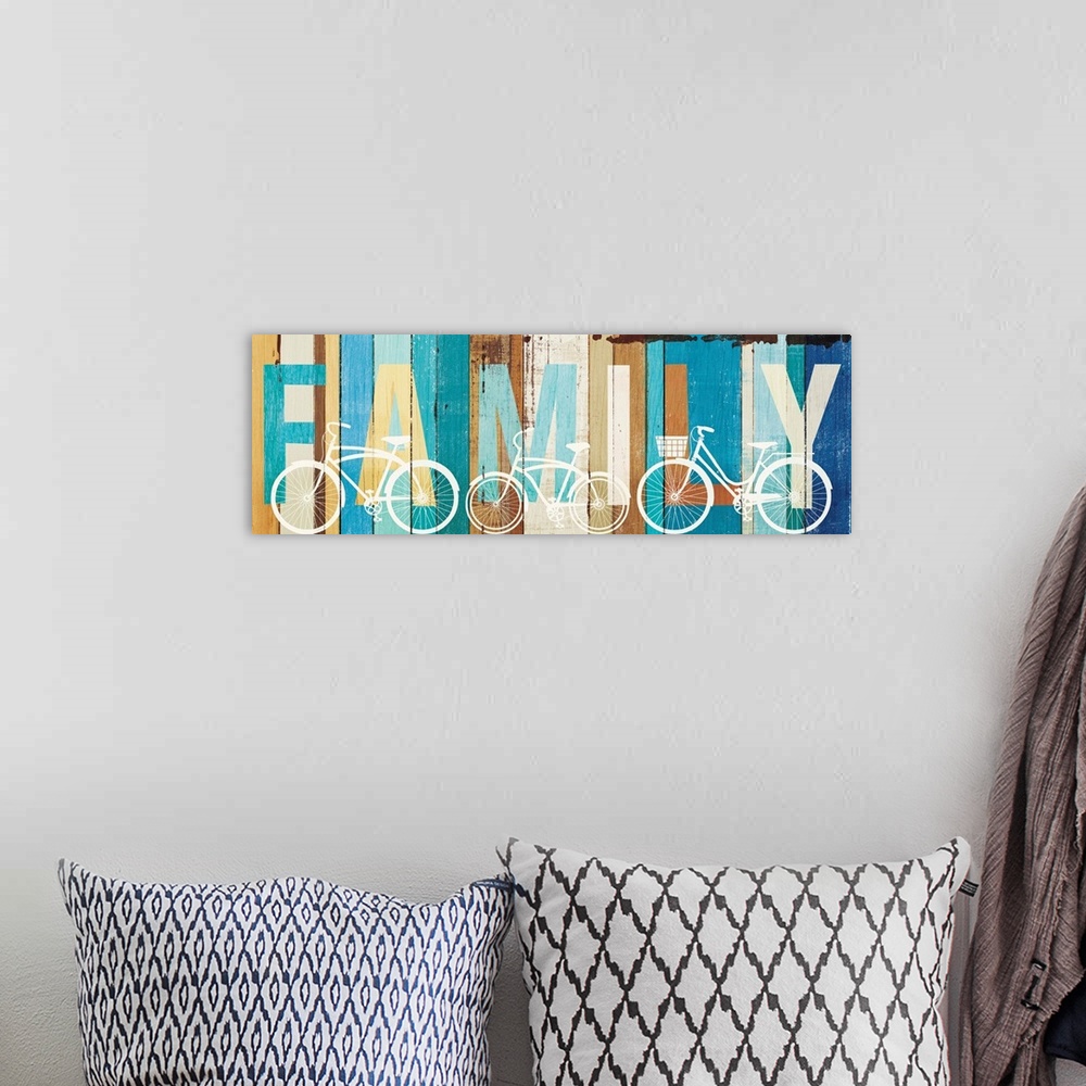 A bohemian room featuring "FAMILY" painted on wood panels with white silhouettes of bicycles.