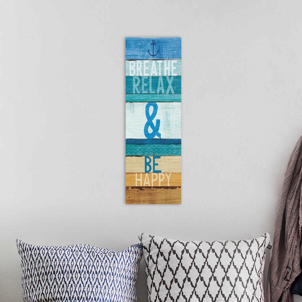 A bohemian room featuring "Breathe Relax and Be Happy" written on blue and tan rectangular shaped stained wood pieces.