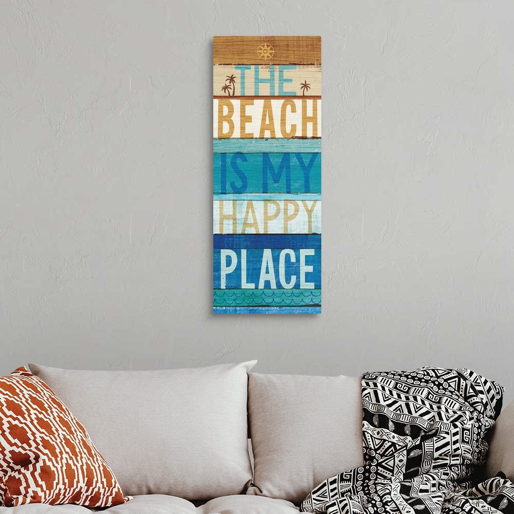 A bohemian room featuring "The Beach Is My Happy Place" on a blue and tan wood paneled background.