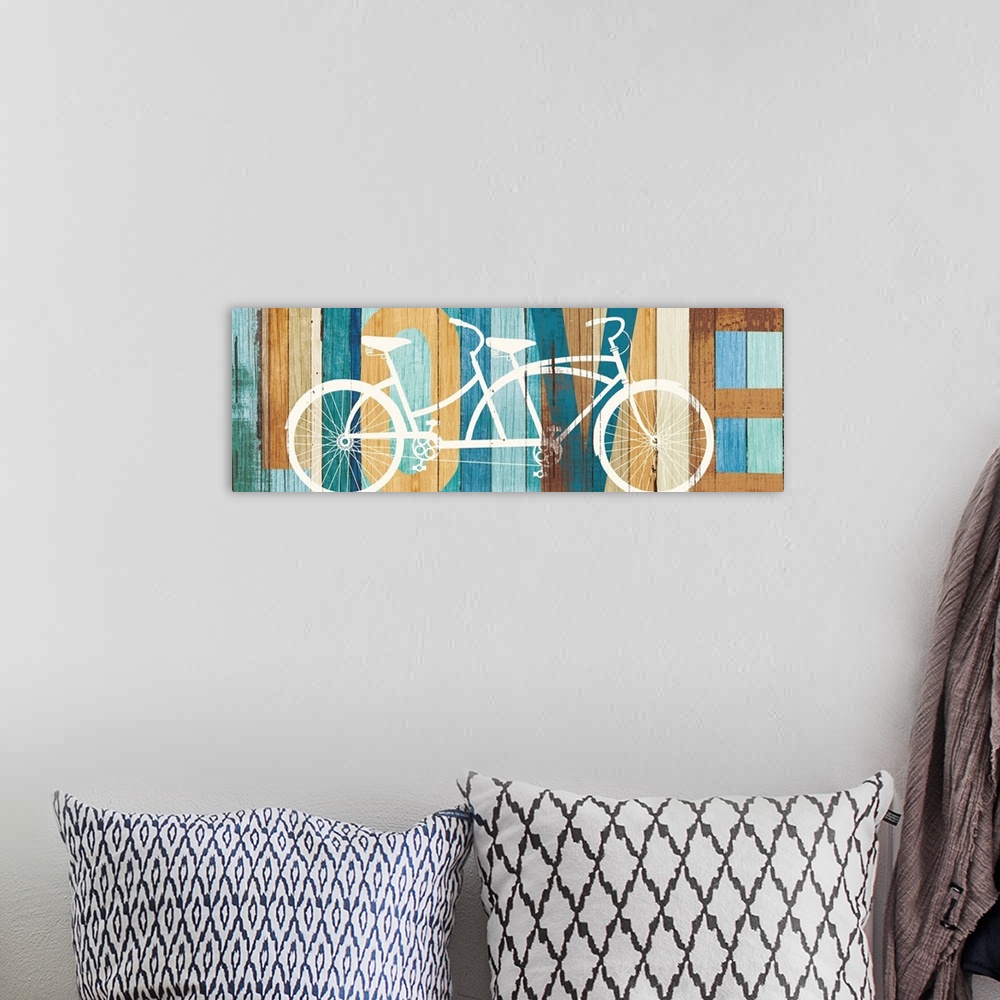 A bohemian room featuring "LOVE" painted on a wood paneled background with a white silhouette of a tandem bicycle on top.