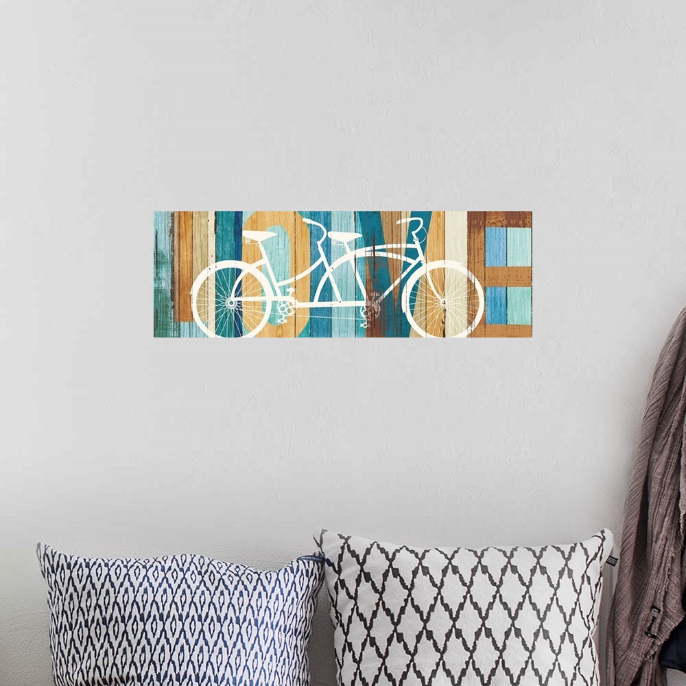 A bohemian room featuring "LOVE" painted on a wood paneled background with a white silhouette of a tandem bicycle on top.