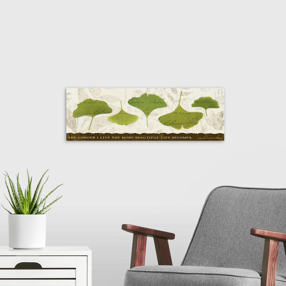 A modern room featuring Big, horizontal wall hanging of five green leaves with scripted text running through them, on a n...