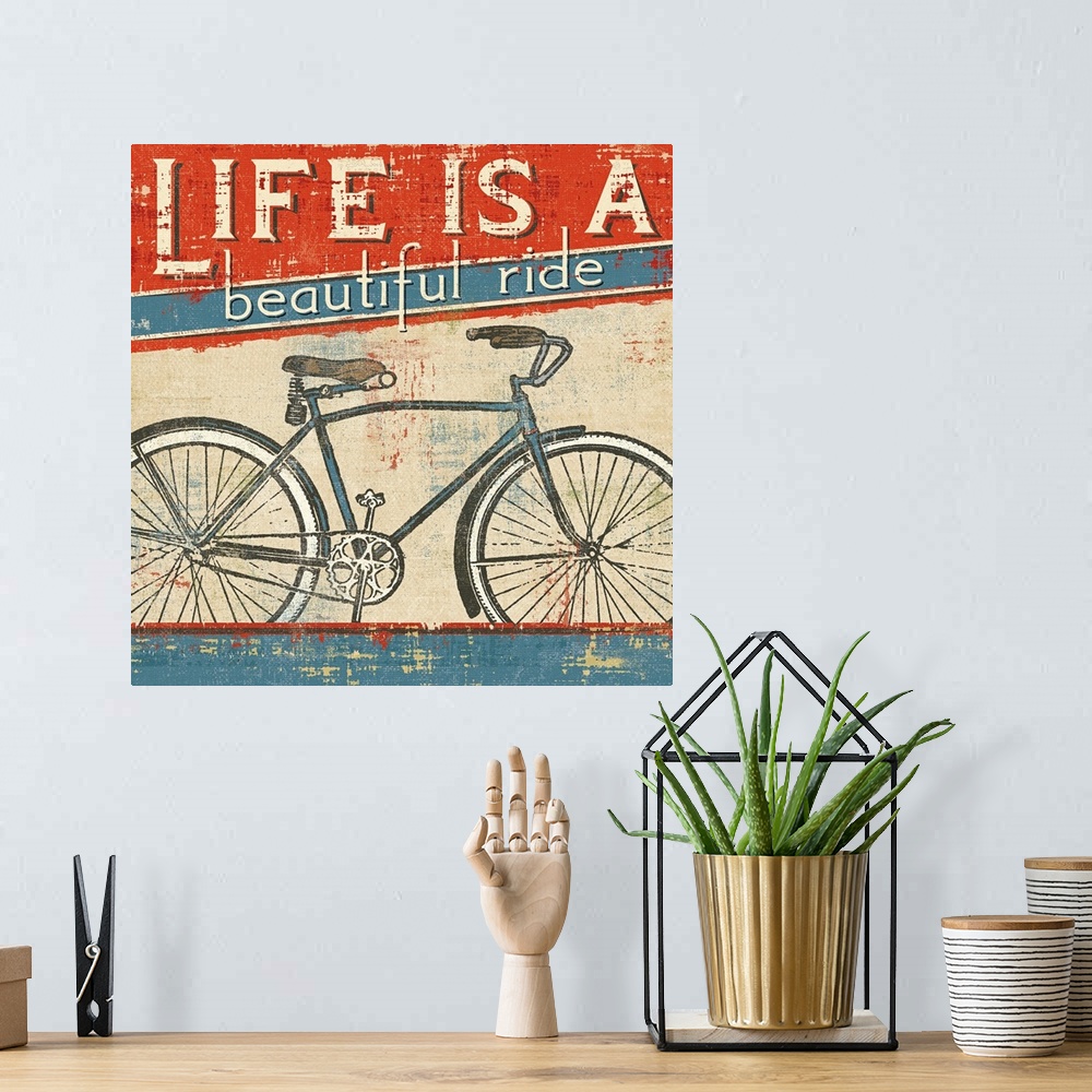 A bohemian room featuring Square wall art of a bicycle with retro typography inspired by vintage posters.