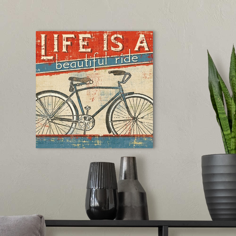 A modern room featuring Square wall art of a bicycle with retro typography inspired by vintage posters.
