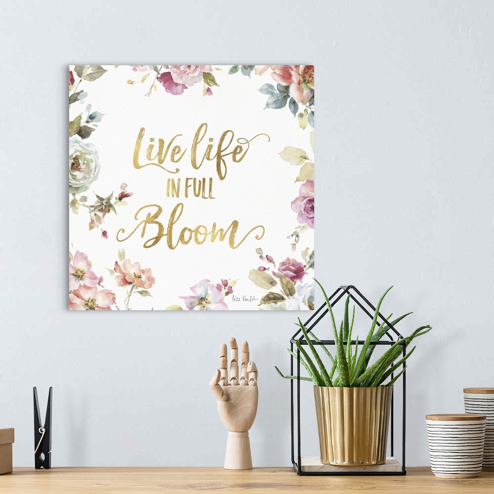 A bohemian room featuring "Live Life in Full Bloom" written in gold  and surrounded by a watercolor floral print.