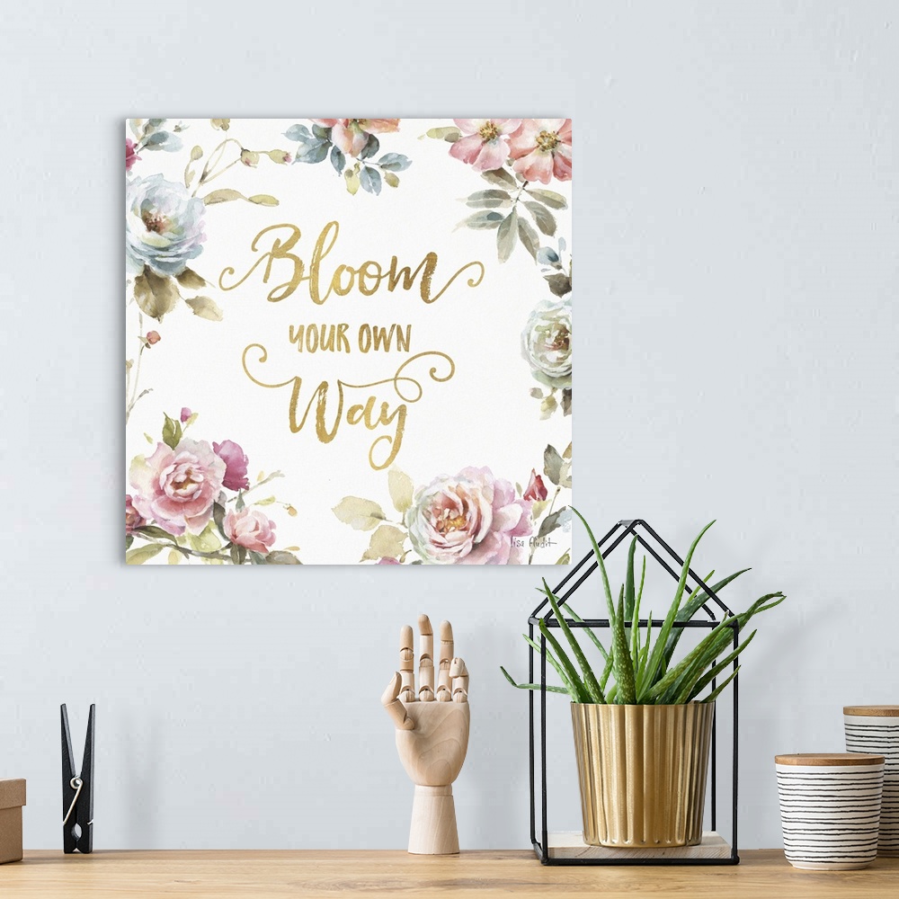A bohemian room featuring "Bloom Your Own Way" written in gold and surrounded by a watercolor floral print.