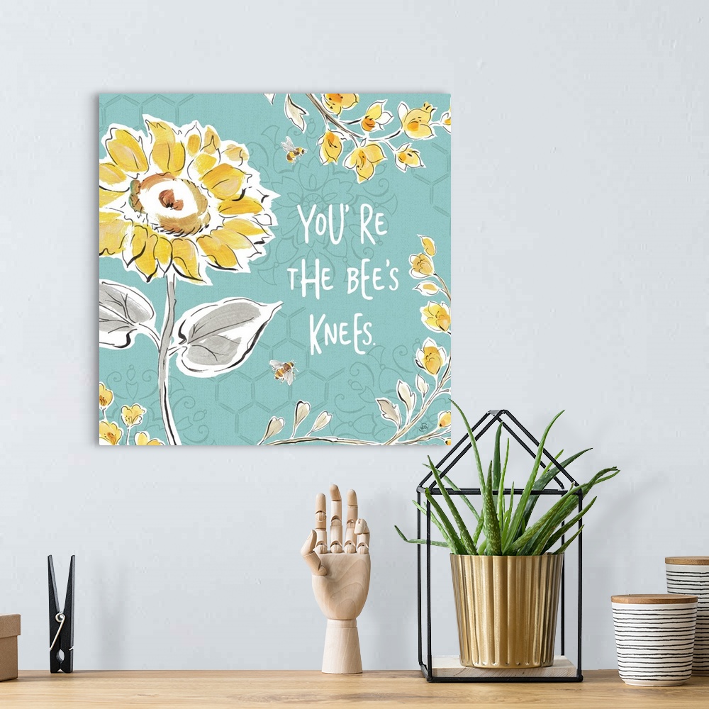 A bohemian room featuring "You're The Bee's Knees" written in white on a blue background with illustrations of yellow flowe...
