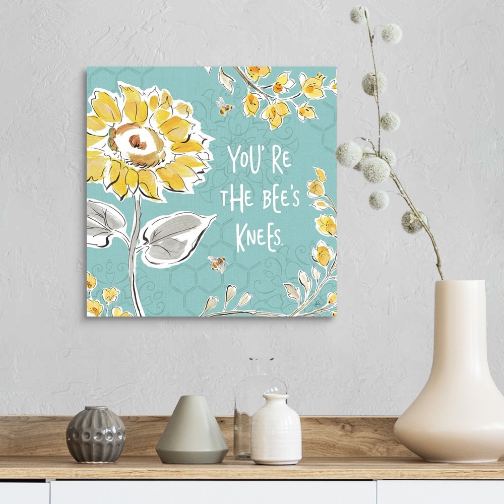 A farmhouse room featuring "You're The Bee's Knees" written in white on a blue background with illustrations of yellow flowe...