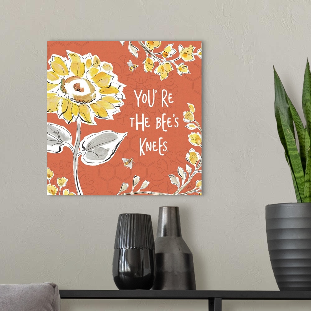 A modern room featuring "You're The Bee's Knees" written in white on a dark coral colored background with illustrations o...