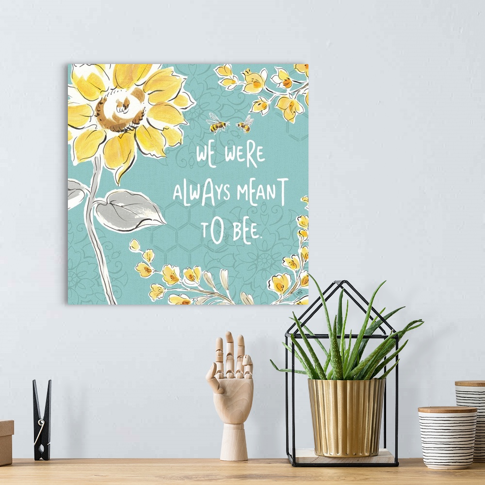 A bohemian room featuring "We Were Always Meant To Be" written in white on a blue background with illustrations of yellow f...