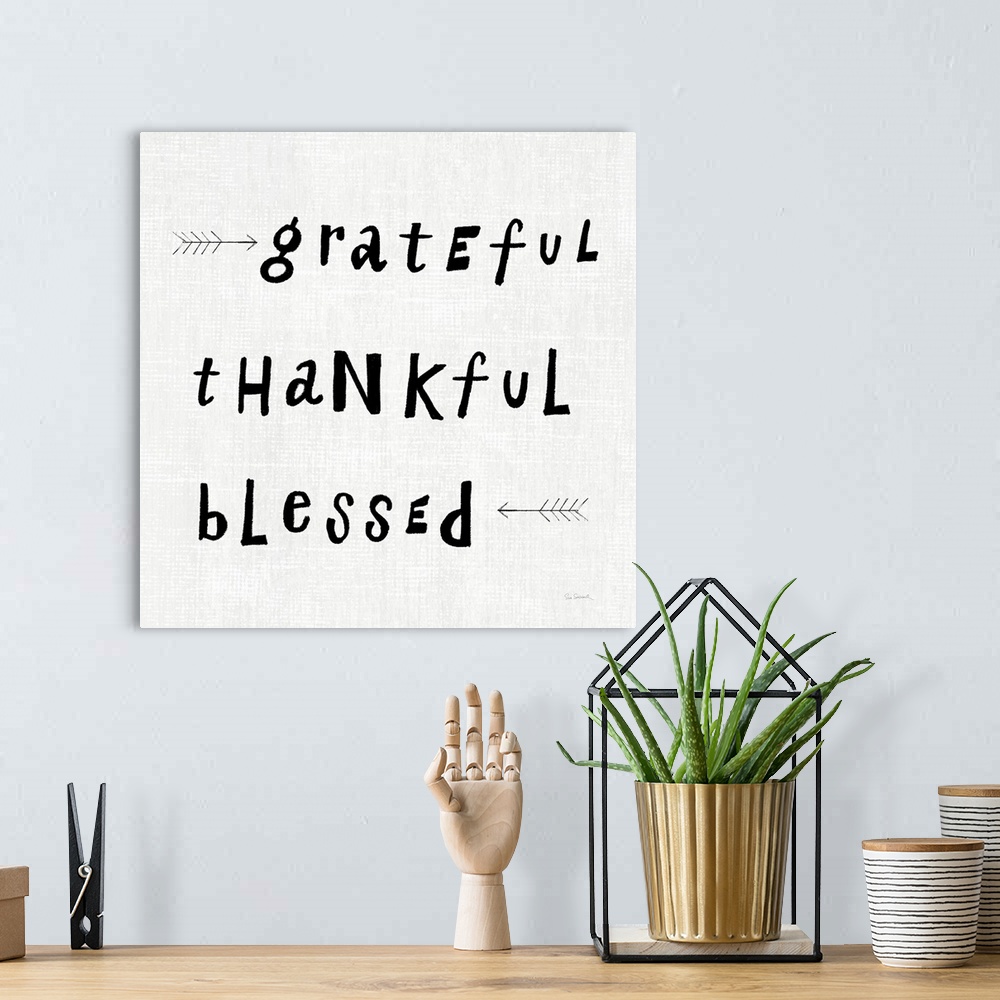 A bohemian room featuring "Grateful thankful Blessed" on a light textured weave backdrop.