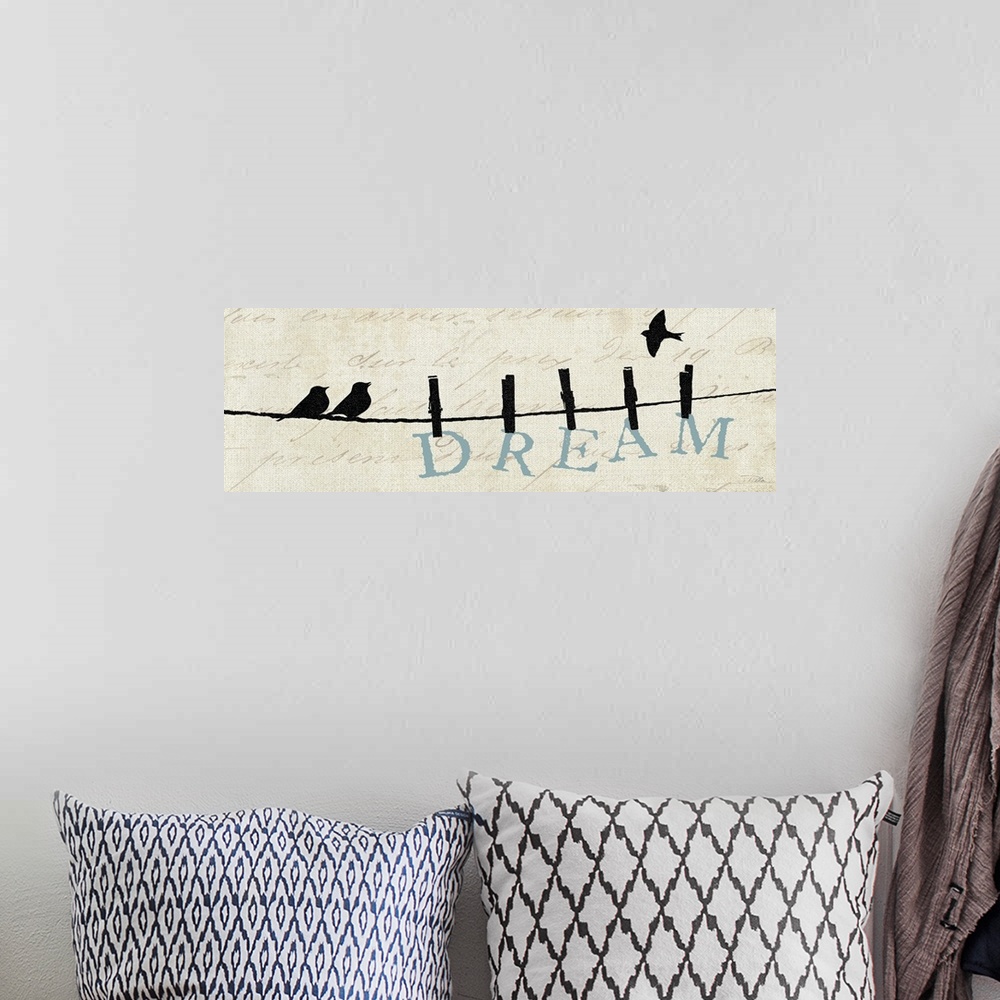 A bohemian room featuring Contemporary artwork of silhouetted birds on a wire with the word "Dream" hanging from the line.