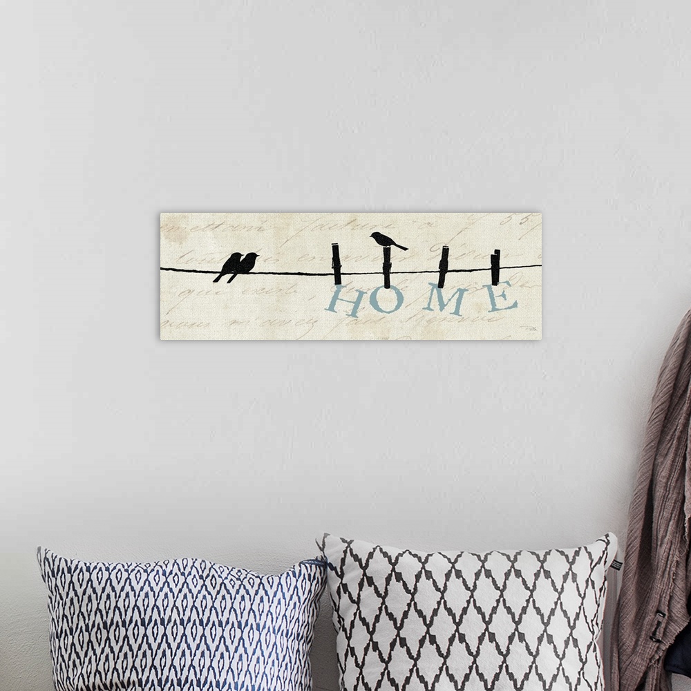 A bohemian room featuring Contemporary artwork of silhouetted birds on a wire with the word "Home" hanging from the line.