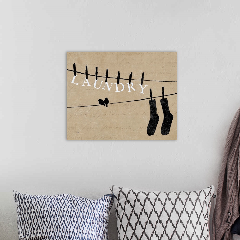 A bohemian room featuring Contemporary artwork of silhouetted birds on cloths lines, with words and a pair of socks hanging...