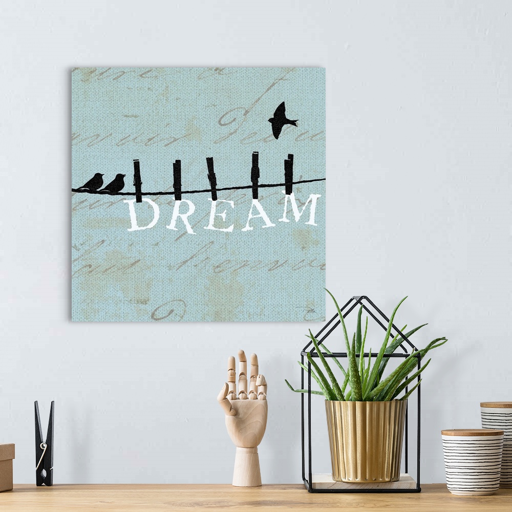 A bohemian room featuring Contemporary artwork of birds silhouetted on a cloths line, with the word "DREAM" hanging from th...