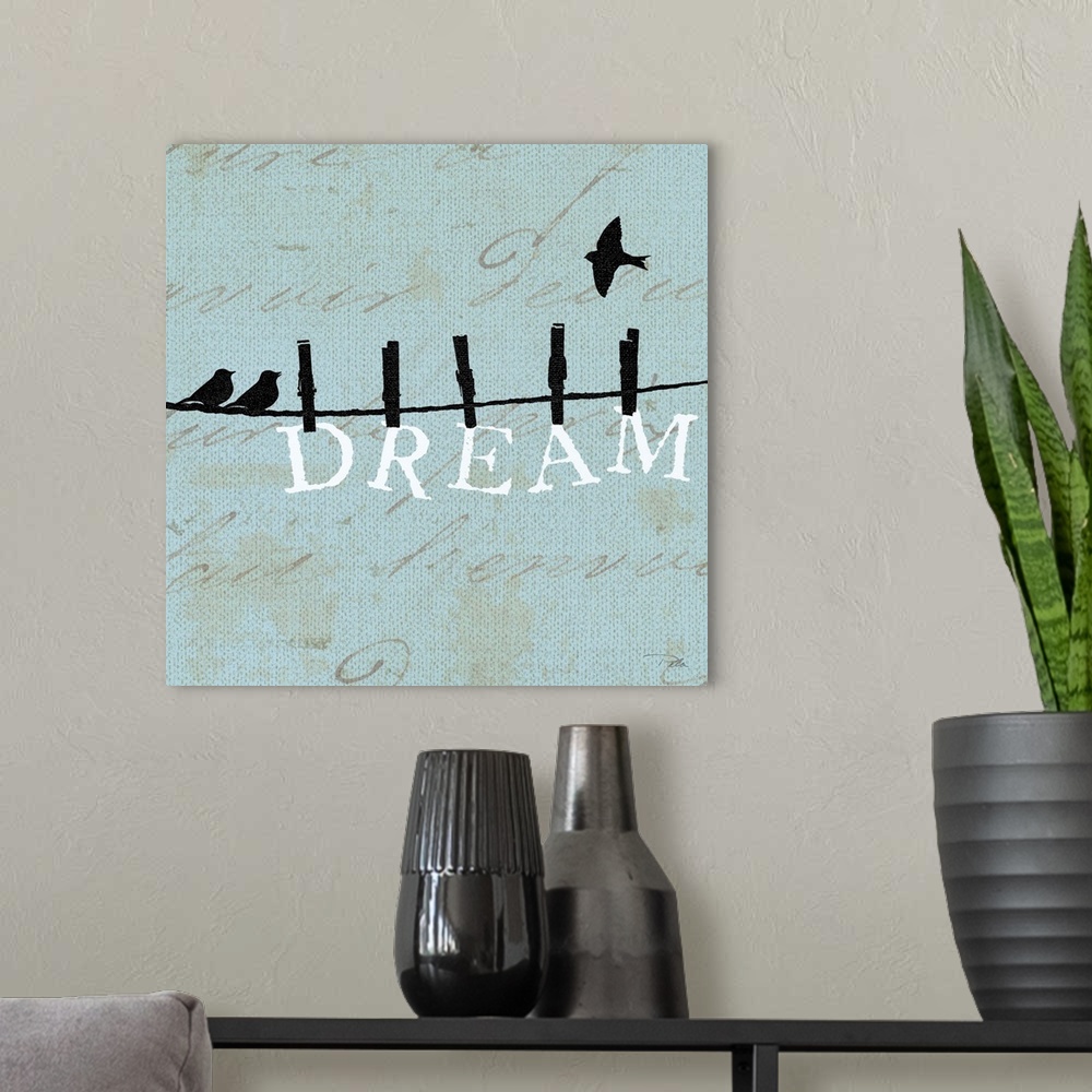 A modern room featuring Contemporary artwork of birds silhouetted on a cloths line, with the word "DREAM" hanging from th...