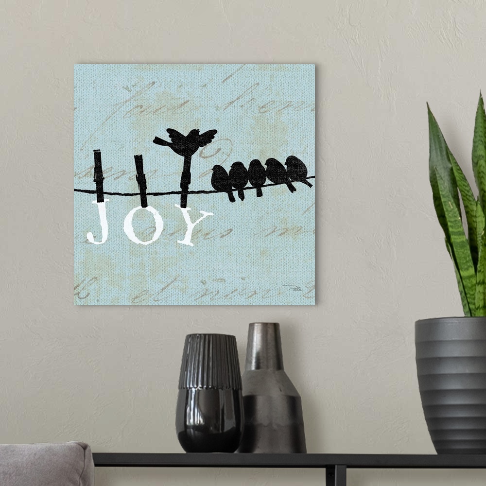 A modern room featuring Contemporary artwork of birds silhouetted on a cloths line, with the word "JOY" hanging from the ...