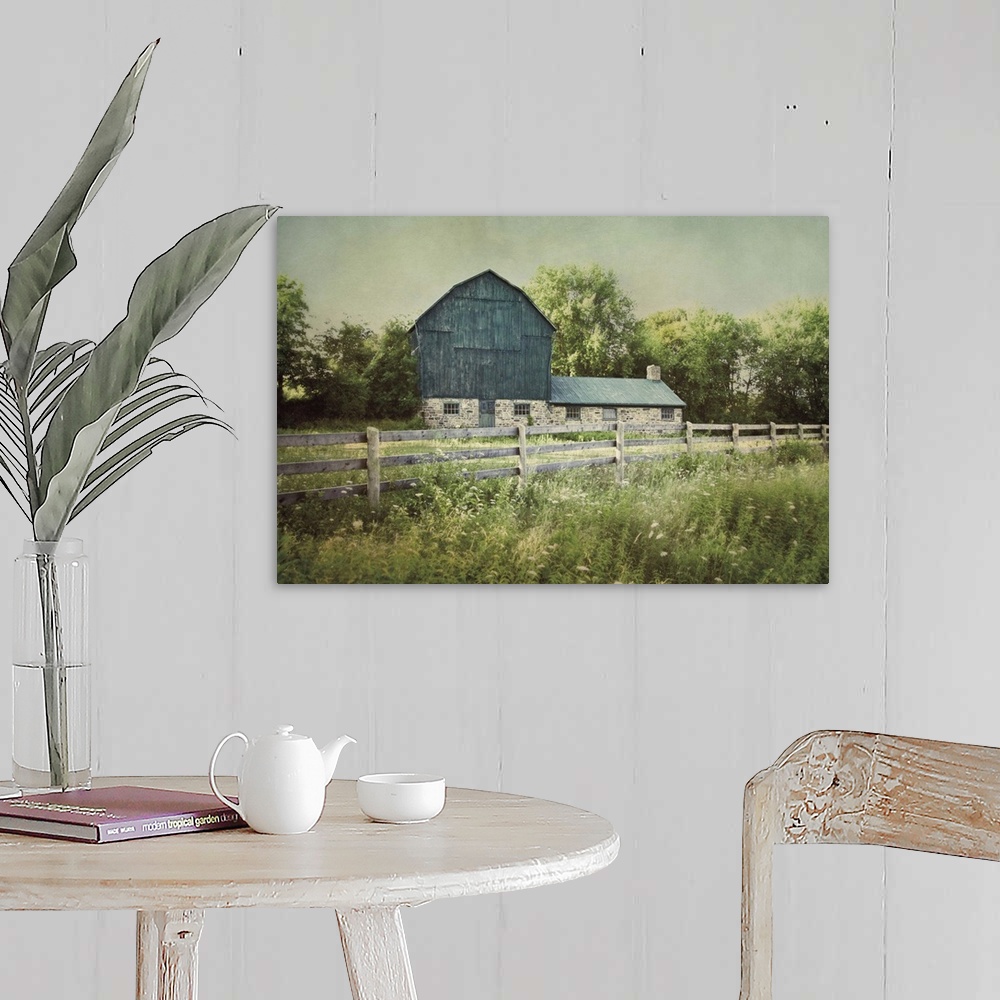 A farmhouse room featuring A photograph of a blue barn.
