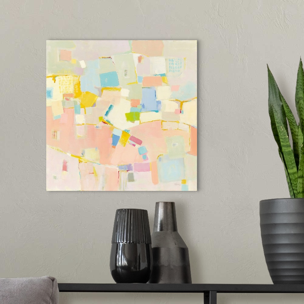 A modern room featuring Abstract artwork featuring rectangular shapes in warm colors over a light gray background.