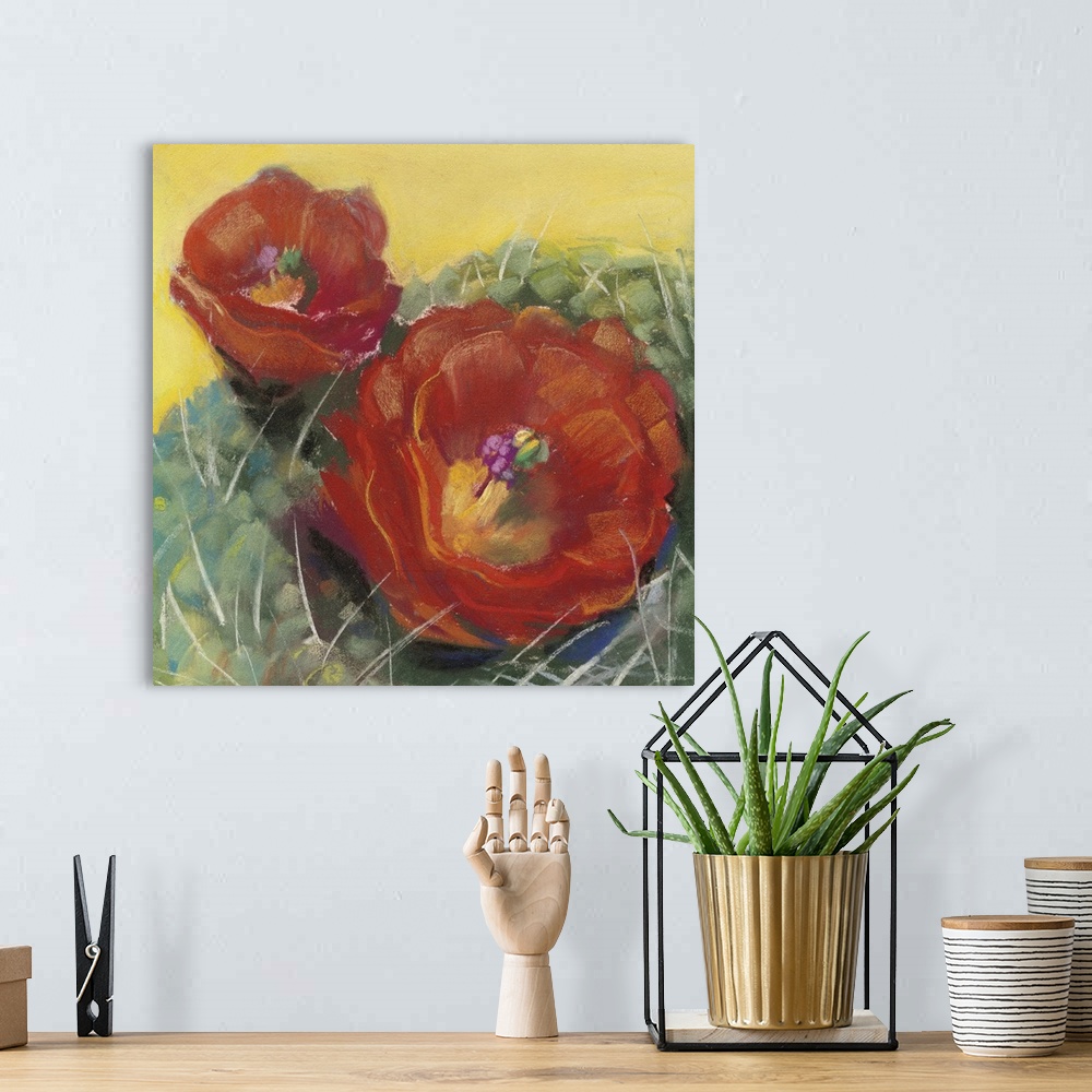 A bohemian room featuring A square contemporary painting of red blooms on a cactus with a yellow background.
