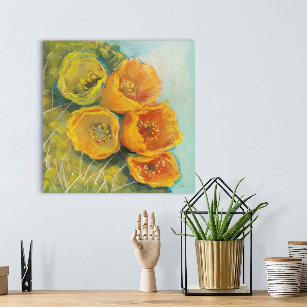 A bohemian room featuring A square contemporary painting of yellow blooms on a cactus with a blue background.