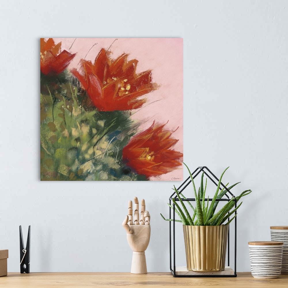 A bohemian room featuring A square contemporary painting of orange blooms on a cactus with a pink background.