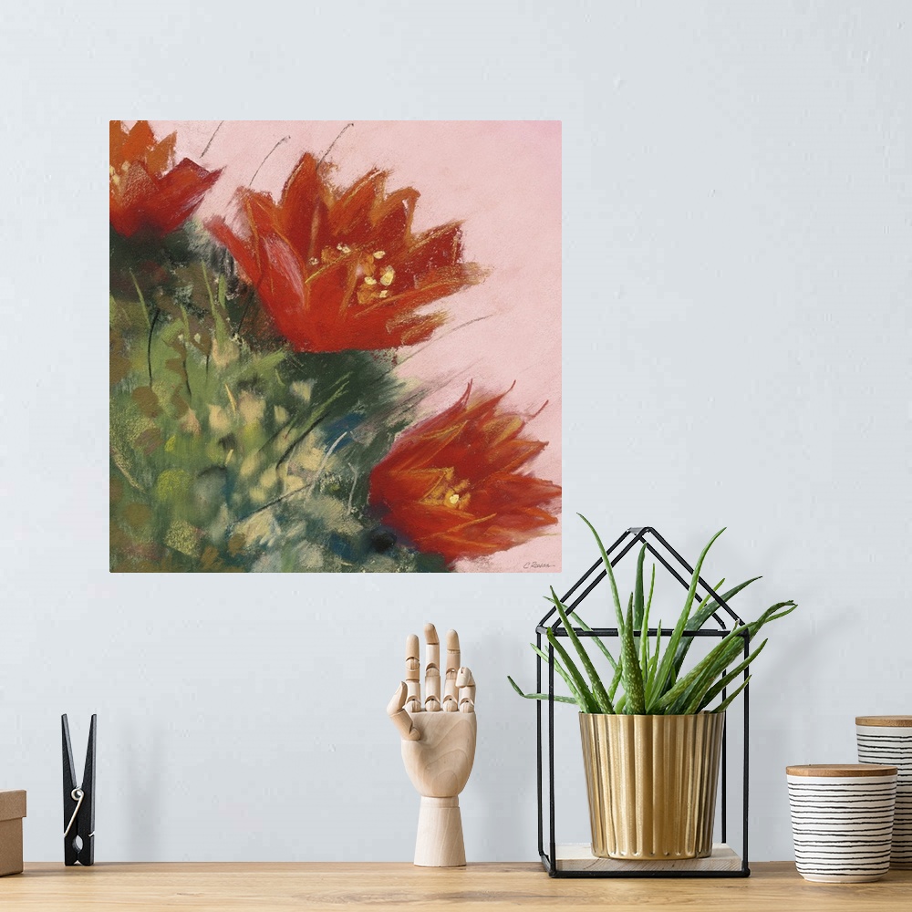 A bohemian room featuring A square contemporary painting of orange blooms on a cactus with a pink background.