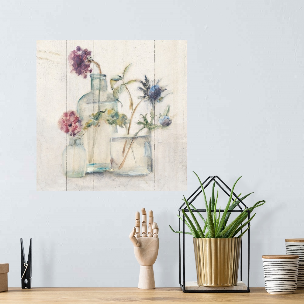 A bohemian room featuring Square artwork with flowers in glass vases on a rustic shiplap background.