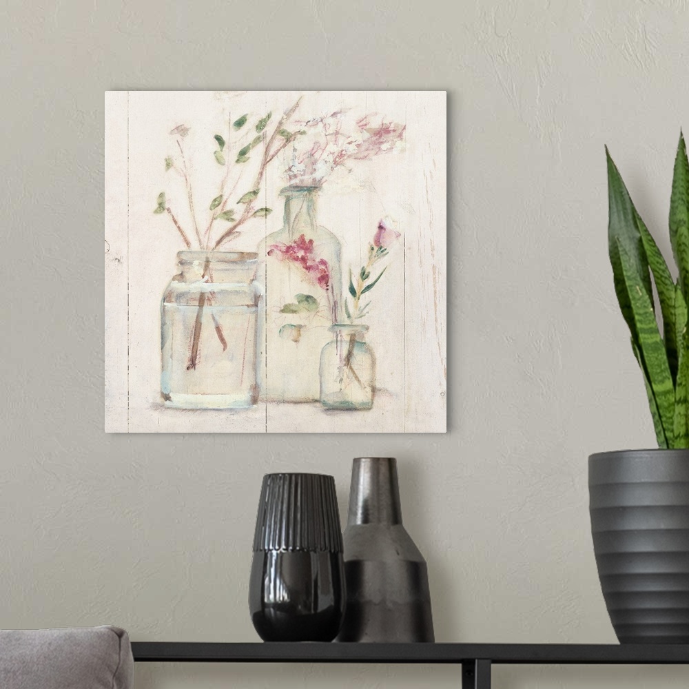 A modern room featuring Square artwork with flowers and branches in glass vases on a rustic shiplap background.