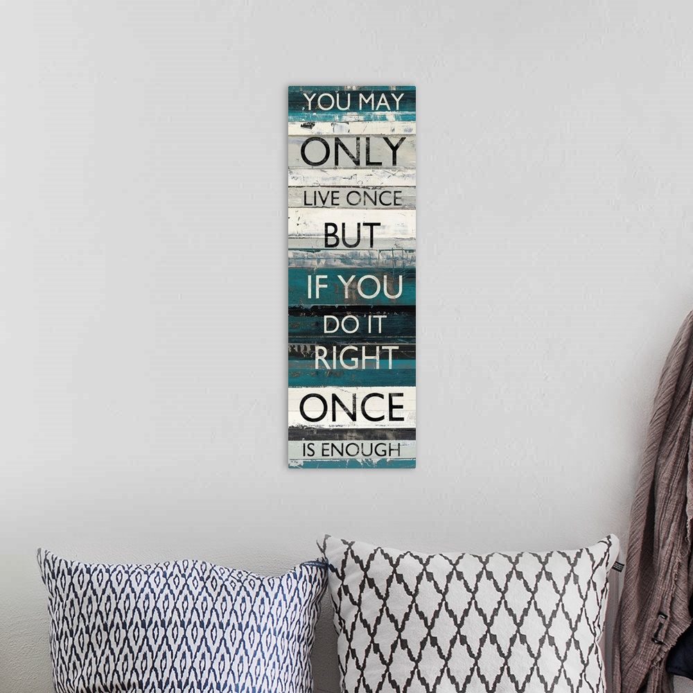 A bohemian room featuring Contemporary artwork of lines of text stacked vertically against a background of different blue t...