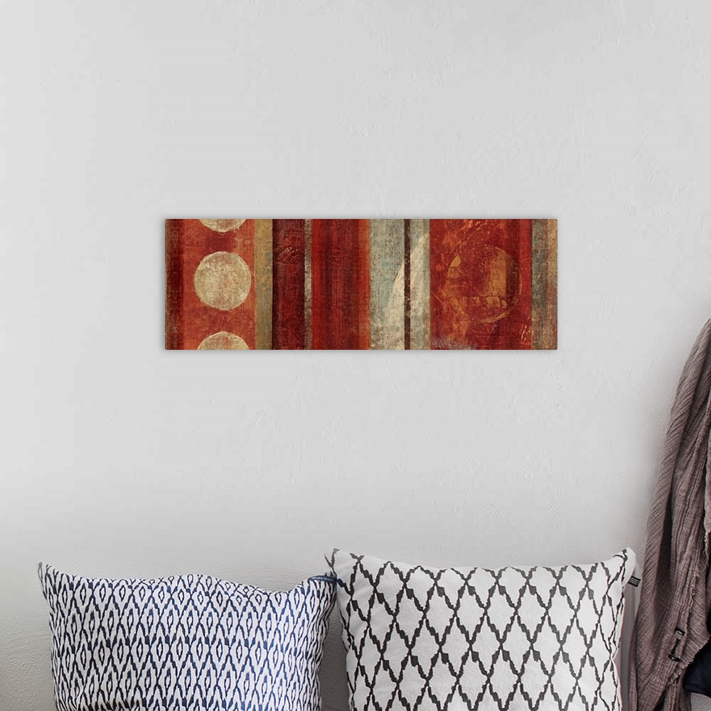 A bohemian room featuring Abstract painting with circles against vertical stripes in earthy tones.