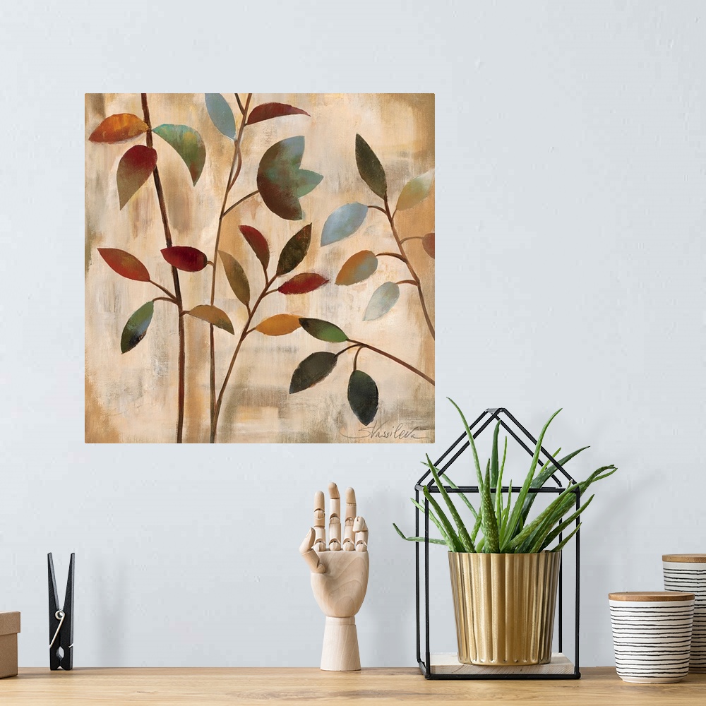 A bohemian room featuring Docor artwork of four thin branches with colorful leaves on a textured, neutral background.