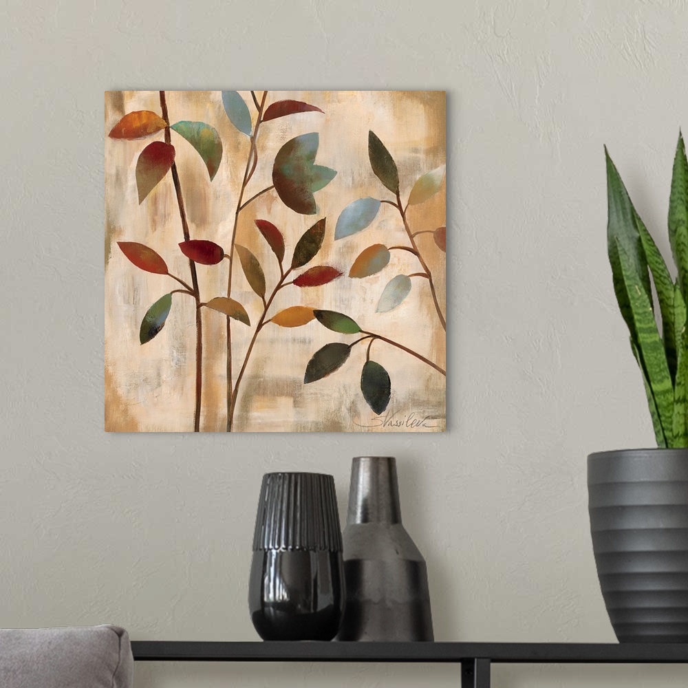 A modern room featuring Docor artwork of four thin branches with colorful leaves on a textured, neutral background.