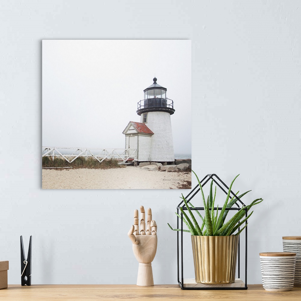 A bohemian room featuring A square photograph of the Brant Point Lighthouse in Nantucket Island, Massachusetts, blanketed i...