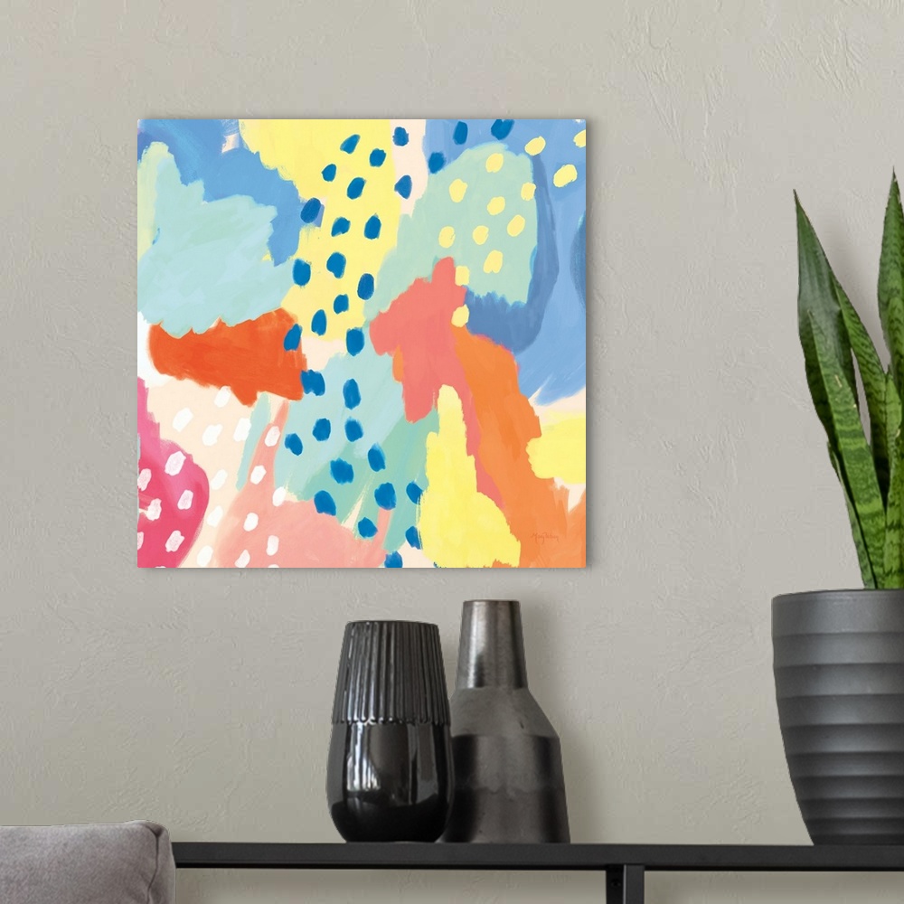 A modern room featuring Decorative abstract art featuring brightly colored sections and dots as accents.