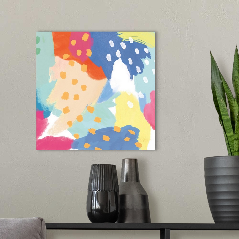 A modern room featuring Decorative abstract art featuring brightly colored sections and dots as accents.