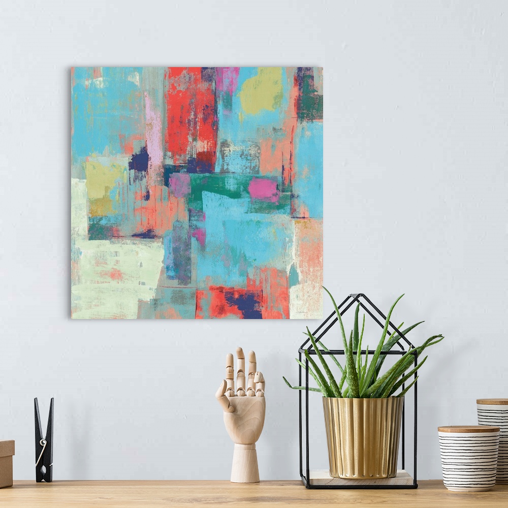 A bohemian room featuring Colorful abstract painting with layers of color on a square canvas.