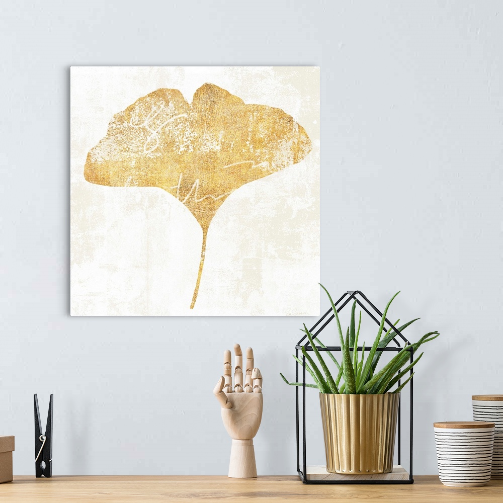 A bohemian room featuring Gold silhouette of a leaf with white writing.