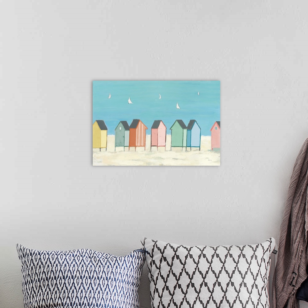 A bohemian room featuring Decorative artwork of colorful sea shacks at the beach with sailboats floating in the distance.