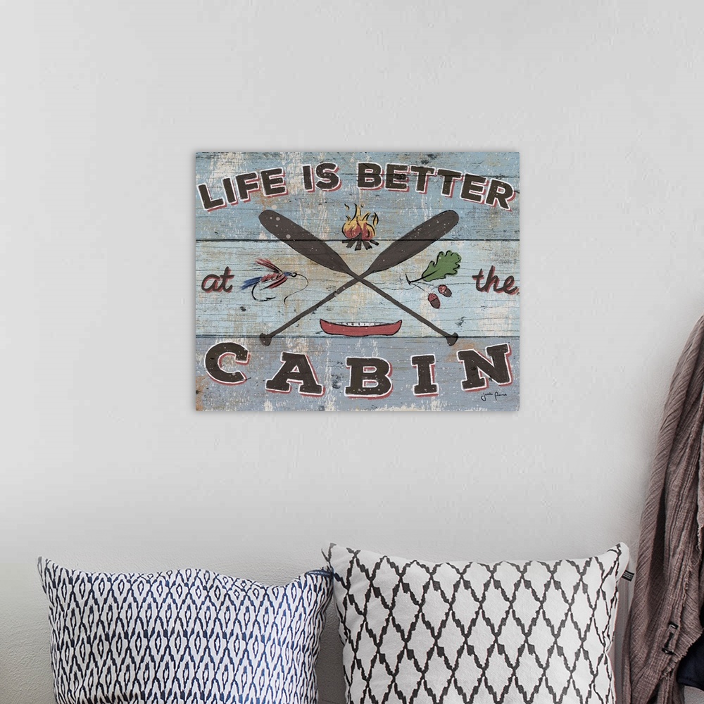 A bohemian room featuring Vintage style image on a wooden board background of crossed paddles and "Life is Better at the Ca...