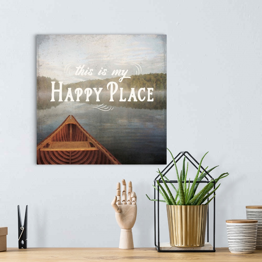A bohemian room featuring "This is My Happy Place" written over an illustration of a canoe on the lake.
