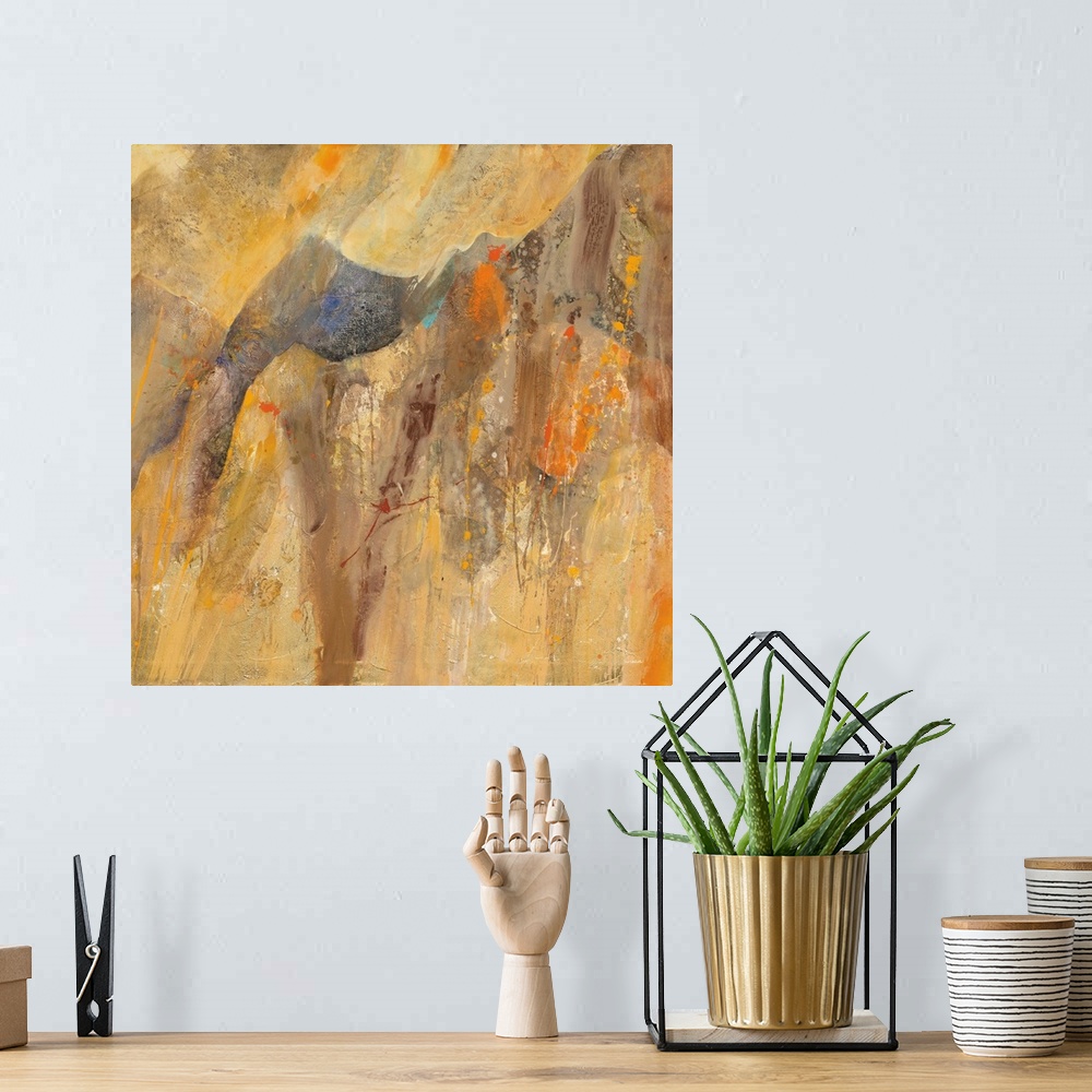 A bohemian room featuring Square abstract painting with brown, orange, cream, and yellow hues resembling a canyon with smal...