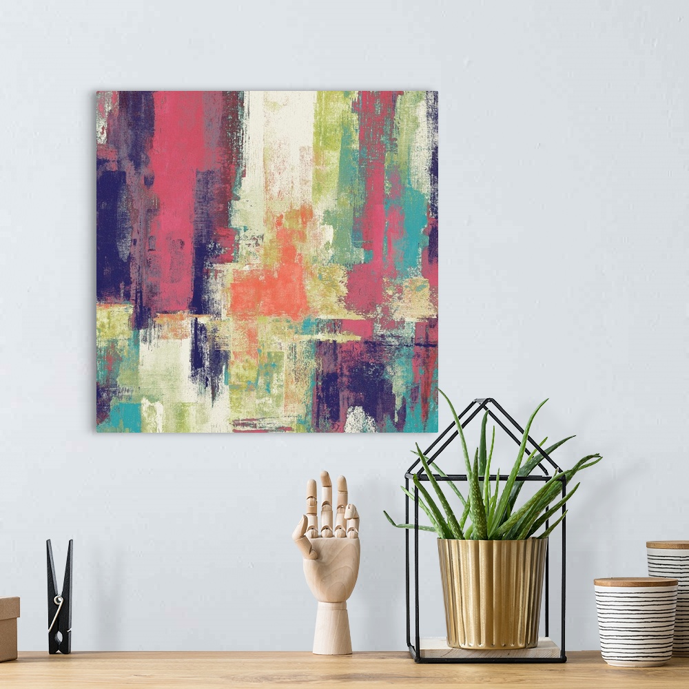A bohemian room featuring Square abstract painting with bold colors layered on top of each other.
