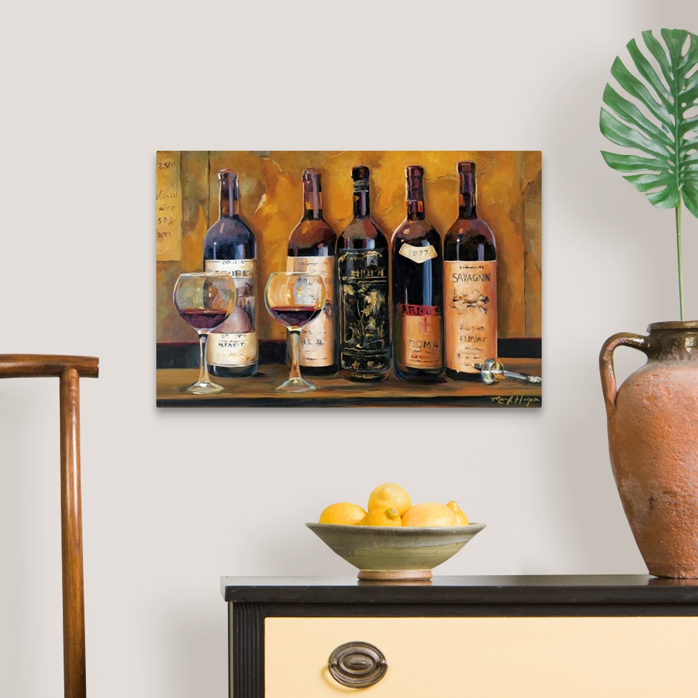 A traditional room featuring Landscape wall painting of five bottles of red wine with two full wine glasses sitting on a count...