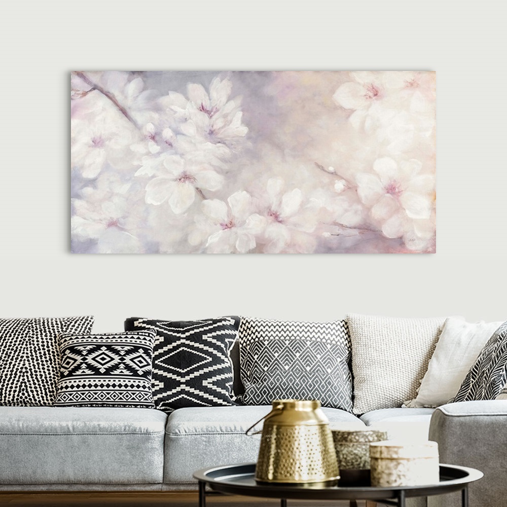 A bohemian room featuring Large abstract watercolor painting of white cherry blossoms on a soft purple, pink, and orange ba...