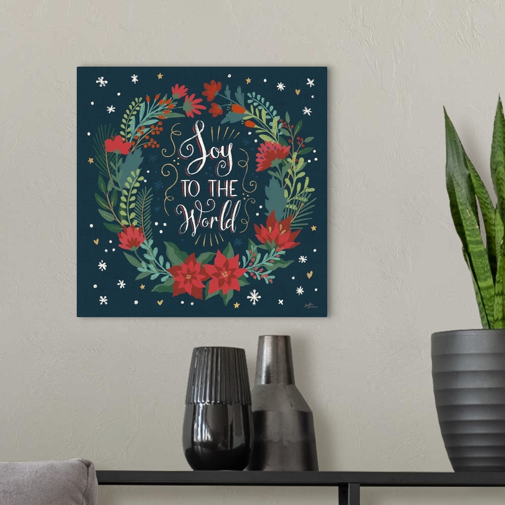 A modern room featuring Decorative artwork of a wreath surrounding the text "Joy To the World"  on a dark navy background.