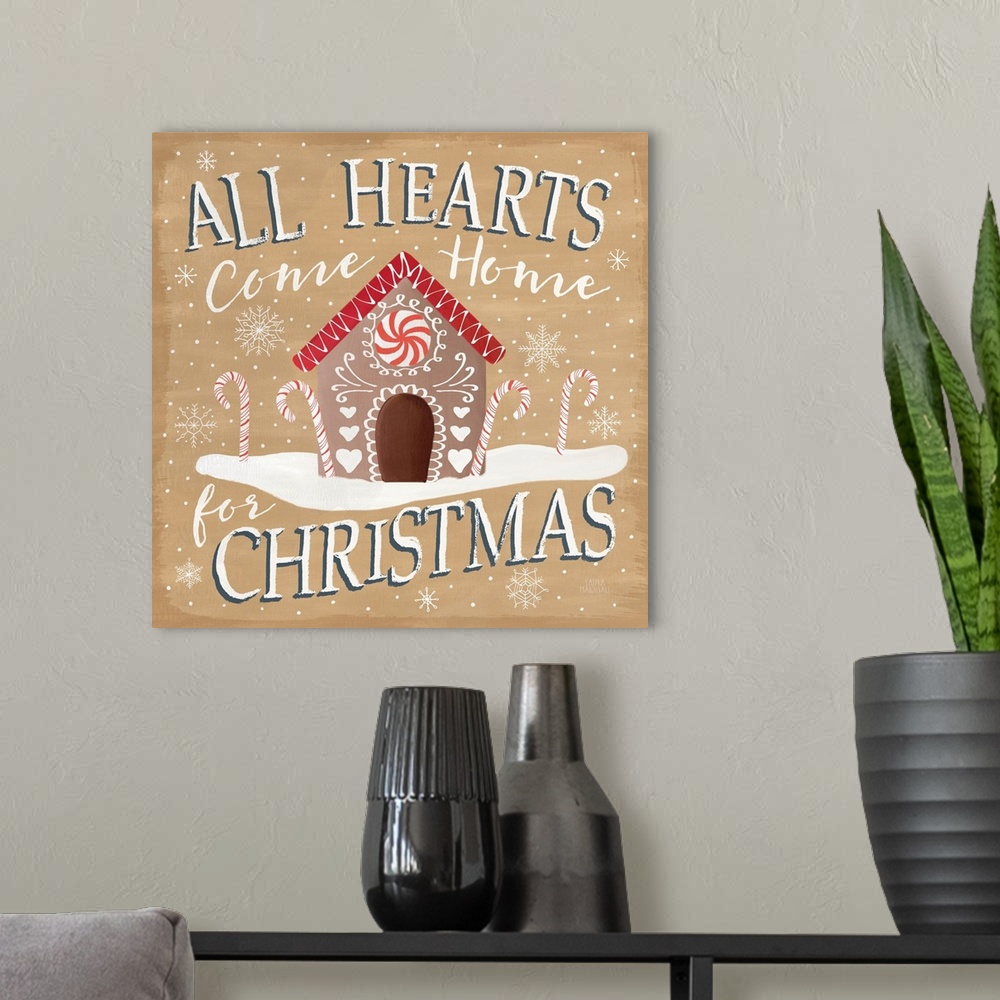 A modern room featuring Square decorative artwork of a gingerbread house with the text "All Hearts Come Home for Christma...