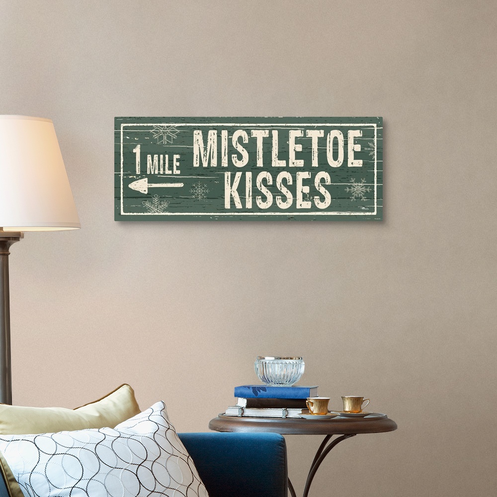 A traditional room featuring Decorative artwork with a holiday theme with the text "1 Mile Mistletoe Kisses" on a green backdrop.