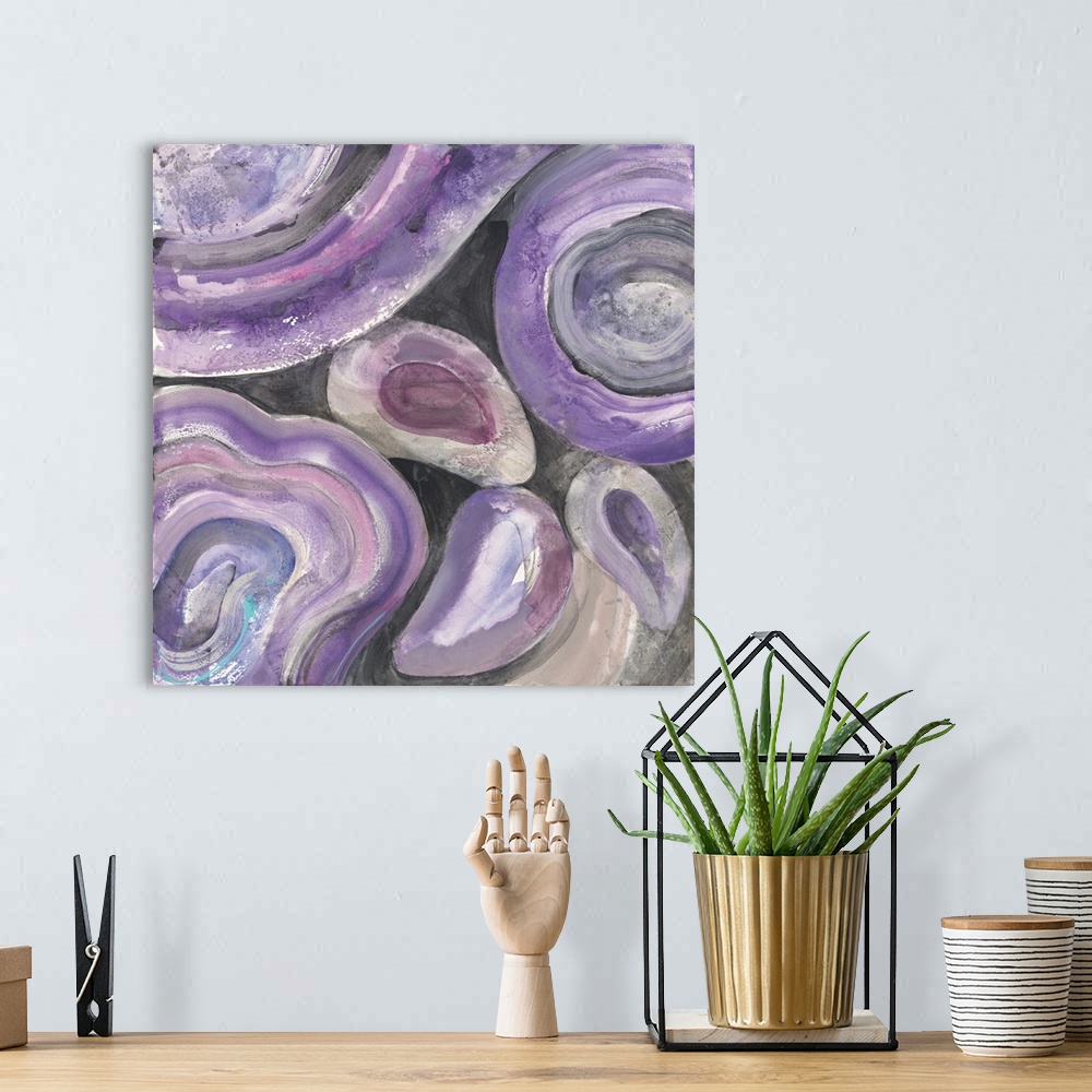 A bohemian room featuring Square abstract painting with rounded purple and pink designs on a black background.