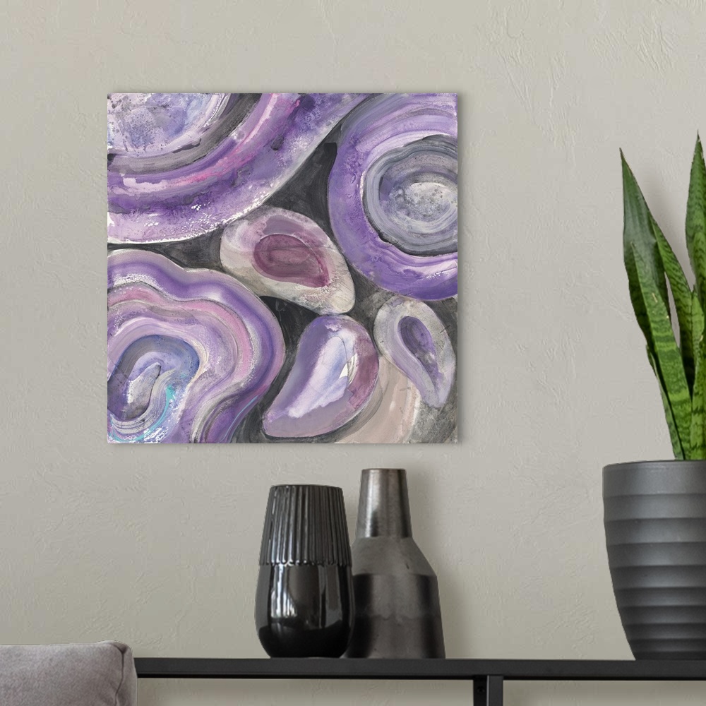 A modern room featuring Square abstract painting with rounded purple and pink designs on a black background.